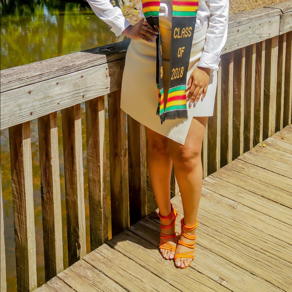 Orange strappy sandals with funky heel